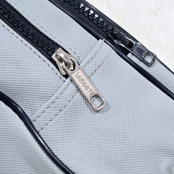 Lacoste mini backpack in a soft light blue shade with navy blue trim accents. - Picture 14 of 16
